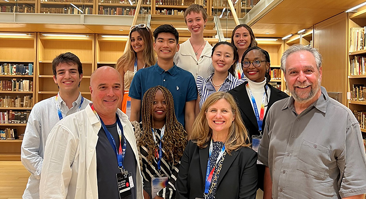 caption: Stavros Niarchos Foundation co-president Andreas Dracopoulos, (front left), Penn President Liz Magill (front center), SNF Paideia founding faculty director Michael X. Delli Carpini (front right), students, and alumni at the Stavros Niarchos Foundation Cultural Center in Athens, Greece in June 2023.