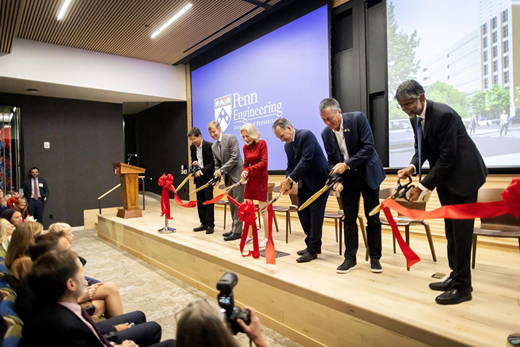 caption: (Left to right) Ramanan Raghavendran, Chair, Board of Trustees; Interim President J. Larry Jameson; Penn President Emerita Amy Gutmann; trustee Harlan Stone; chair, Penn Engineering Board of Advisors Rob Stavis; and Penn Engineering Nemirovsky Family Dean Vijay Kumar cut the ribbon on Amy Gutmann Hall, the University’s new center for data science and  artificial intelligence, on September 27, 2024. Photo by Eric Sucar.