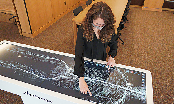 caption: Visualizationist Lexi Voss demonstrates some of the functions of the Anatomage table. Photo Courtesy Penn Libraries