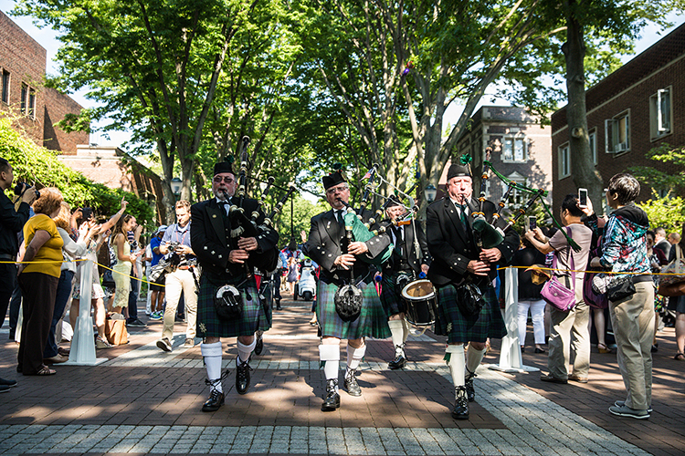 caption: The bagpipers could be heard leading the way through campus.