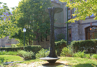 caption: Double Lake Falls by Bryan Hunt was donated by Wharton alumnus Theodore Aronson and his wife, Barbara in 2013. The 9.5 foot statue, which was cast in bronze in 2002, was installed in the Shakespeare Garden outside of Fisher Fine Arts Library in August 2015.