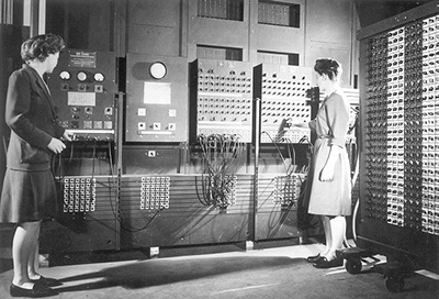 caption: Frances Bilas and Elizabeth Jennings, two of the women programmers, in front of the Electronic Numerical Integrator and Computer (known as ENIAC) circa 1946. ENIAC was developed at Penn’s Moore School, 1943-1945.