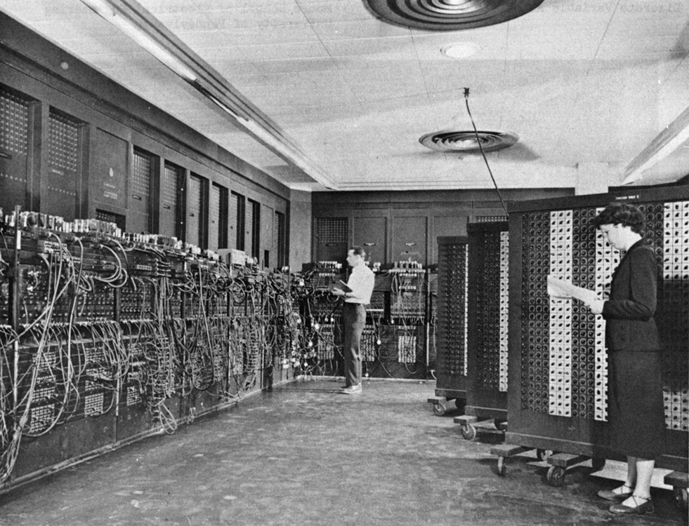 caption: Glen Beck (background) and Betty Holberton (foreground) programming the ENIAC, circa 1947-1955.