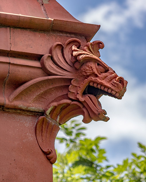 caption: Frank Furness designed this dragon-like creature (who guards the Fisher Fine Arts Library) as a true gargoyle, with water emerging from its mouth. In a 1990 renovation, the downspout was removed, and today the dragon is purely ornamental. 