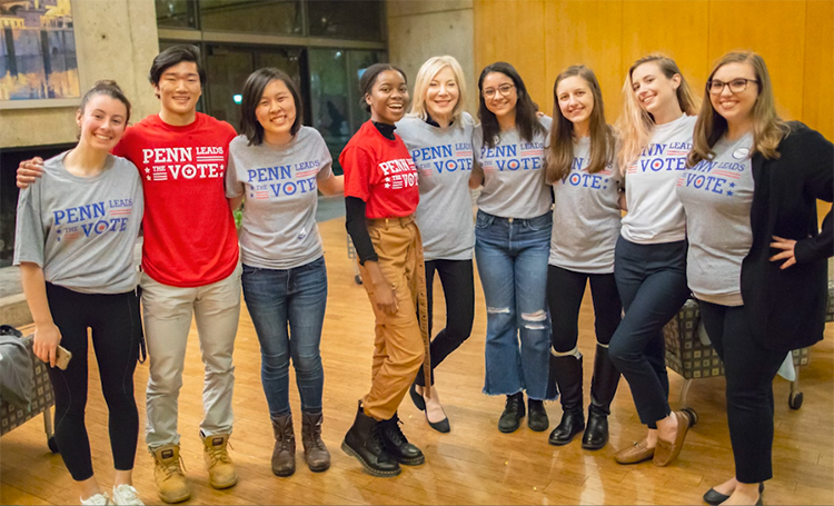 caption: Amy Gutmann poses with student leaders of Penn Leads the Vote in a pre-pandemic photo. 