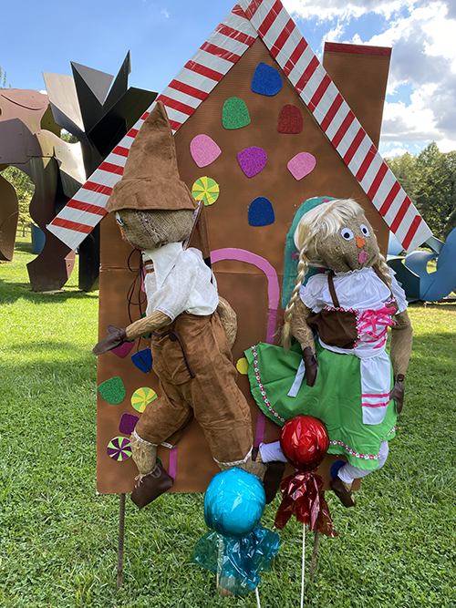 caption: A Hansel and Gretel scarecrow display. 