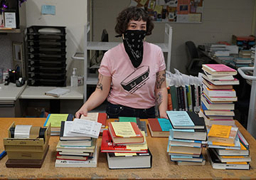 caption: Library Assistant Jillian Richards prepares requested books for shipment.