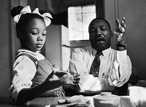 caption: Dr. Martin Luther King, Jr. with his daughter Yolanda King. Photo by James Karales.