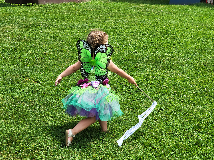 caption: A visitor in a butterfly costume at Morris Arboretum & Gardens. Photo by Mellany Armstrong.