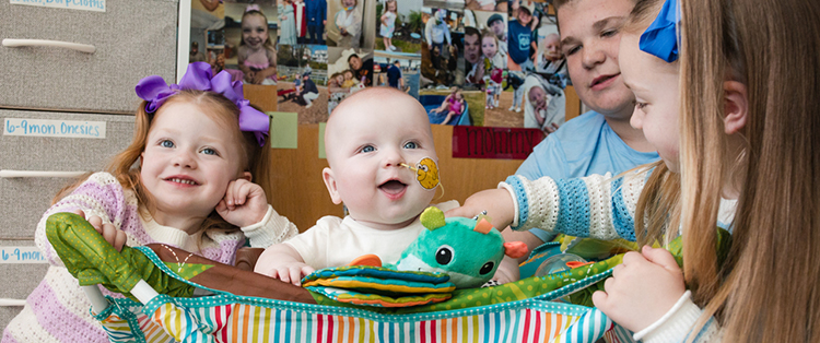 caption: KJ (center) pictured with his siblings.