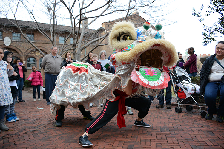 caption: Students from Cheung's Hung Gar Kung Fu Academy take part in the Lion Dance Parade.