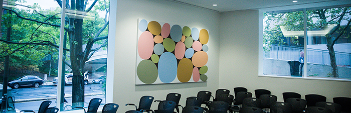 A brightly-colored mural with several circular shapes in a conference room