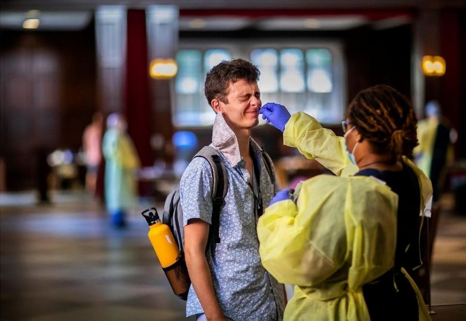 caption: COVID testing indoors at Houston Hall.