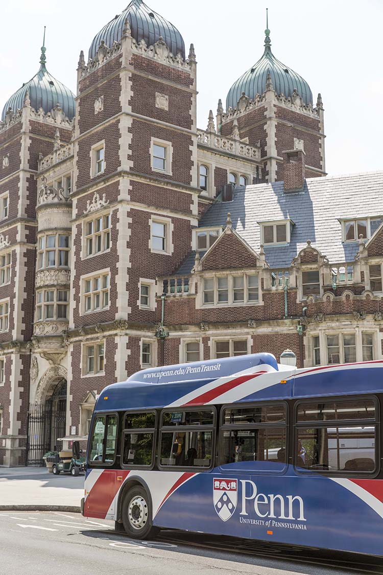 caption: A Penn Transit bus passes by the Quad.