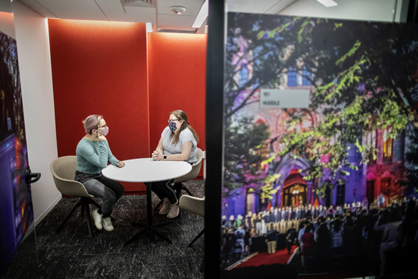 caption: Financial Wellness Program Manager Lyndsi Burcham (right) speaks with peer counselor Dana Kimmelman in one of the Student Service Center’s “huddle rooms.” Photographs by Eric Sucar.
