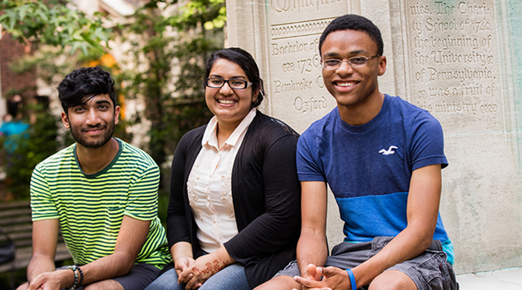 Three people sitting down and smiling
