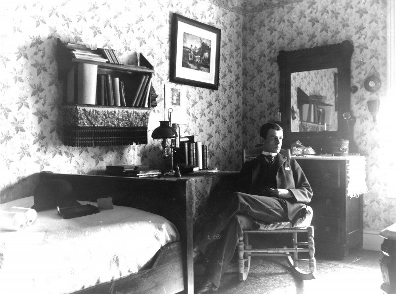 caption: Upper Quadrangle room, ca. 1890s; the University supplied a bedstead, mattress, bureau, washstand table, bookcase, chairs and toilet china.Photograph courtesy of the University Archives.