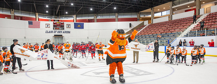 caption: Penn Ice Rink Ribbon Slashing Celebration: Members of the Penn Men’s and Women’s Ice Hockey Clubs and Alumni, along with alumni from Snider Hockey and the Philadelphia Flyers joined special guest Gritty for the ribbon-slashing ceremony.