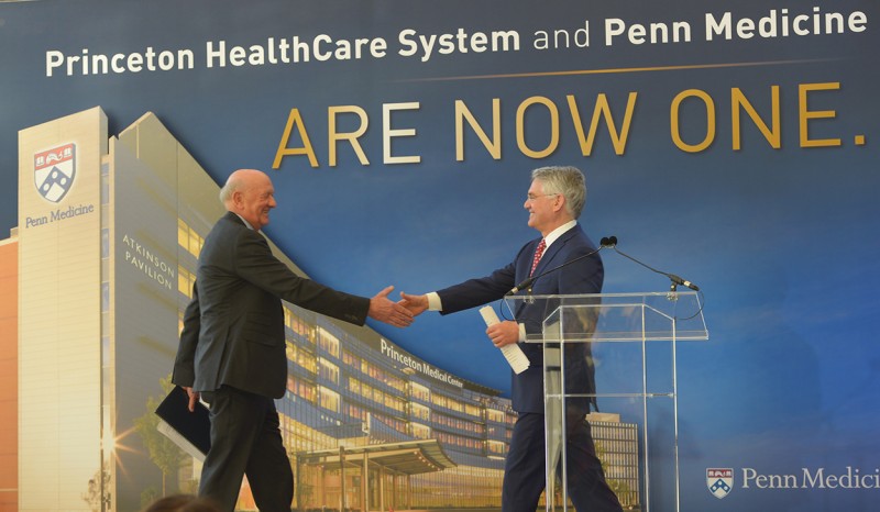 caption: Ralph W. Muller and Barry S. Rabner share a handshake to solidify this “powerful partnership”