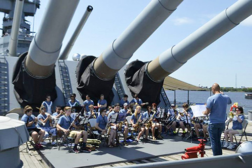 caption: Participants in Penn Band's 2015 Summer Music Camp perform at the Battleship New Jersey