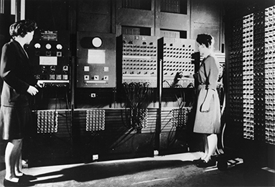caption: Operating ENIAC's main control panel when it was located at the Moore School, Jean Jennings, who led the programmers, and Frances Bilas